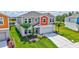 Charming two-story home with colorful accents, manicured lawn, and a well-maintained landscape at 12710 Hysmith Loop, Parrish, FL 34219