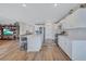 Bright, open kitchen with a large island, modern appliances, and wood flooring at 12710 Hysmith Loop, Parrish, FL 34219