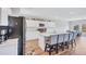 Bright, open kitchen boasts white cabinetry, stainless steel appliances, and a large island with bar seating at 12710 Hysmith Loop, Parrish, FL 34219