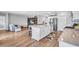 Open-concept kitchen features a large island, stainless appliances, and connects to a cozy living space at 12710 Hysmith Loop, Parrish, FL 34219