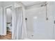 The shower has white tile, a new shower head and sliding glass doors at 12710 Hysmith Loop, Parrish, FL 34219