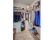 A walk-in closet with ample storage solutions including shelves, rods, and drawers at 12710 Hysmith Loop, Parrish, FL 34219