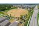 Aerial shot showcasing a community park with a playground and open green space next to a neighborhood at 13529 Wild Ginger St, Riverview, FL 33579