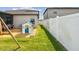 Playful backyard featuring a ' playhouse, side yard and a white fence at 13529 Wild Ginger St, Riverview, FL 33579