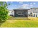 Wide backyard with patio, outdoor seating, grill, playset and view from the porch at 13529 Wild Ginger St, Riverview, FL 33579