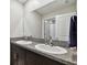Bathroom featuring dual sinks and large mirror at 13529 Wild Ginger St, Riverview, FL 33579