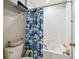 Bathroom featuring shower/tub combo with tile surround and blue shower curtain at 13529 Wild Ginger St, Riverview, FL 33579