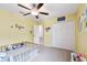 room with a double door closet, yellow walls, and a ceiling fan at 13529 Wild Ginger St, Riverview, FL 33579