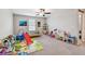 Spacious bonus room with carpet flooring, a ceiling fan, and lots of space for different activities at 13529 Wild Ginger St, Riverview, FL 33579