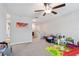 Bright bonus room featuring carpet, neutral paint, and ceiling fan at 13529 Wild Ginger St, Riverview, FL 33579