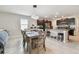 Open-concept dining area adjacent to kitchen, with updated lighting, neutral paint, and tile flooring at 13529 Wild Ginger St, Riverview, FL 33579