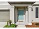 Inviting front porch with a pop of color, meticulous landscaping add curb appeal to this charming home at 13529 Wild Ginger St, Riverview, FL 33579