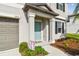 Inviting front porch with a pop of color, meticulous landscaping add curb appeal to this charming home at 13529 Wild Ginger St, Riverview, FL 33579