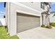 Spacious two-car garage with concrete driveway, and landscaping provide ample parking and curb appeal at 13529 Wild Ginger St, Riverview, FL 33579