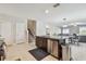 Kitchen with stainless steel appliances and center island that opens to a dining and living area at 13529 Wild Ginger St, Riverview, FL 33579