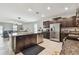 Open kitchen with stainless steel appliances, dark wood cabinetry, and a large island at 13529 Wild Ginger St, Riverview, FL 33579
