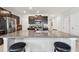 Spacious kitchen featuring granite countertops on the island and a set of barstools for seating at 13529 Wild Ginger St, Riverview, FL 33579