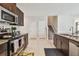 Kitchen with stainless steel appliances, granite countertops, and access to the stairs at 13529 Wild Ginger St, Riverview, FL 33579