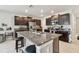 Island featuring granite countertops and seating in a kitchen with stainless appliances and dark wood cabinets at 13529 Wild Ginger St, Riverview, FL 33579