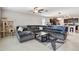 Spacious living room with a large sectional, neutral decor, and an open layout to the kitchen at 13529 Wild Ginger St, Riverview, FL 33579