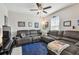 Spacious living room featuring a plush sectional sofa, ceiling fan, and framed wall art at 13529 Wild Ginger St, Riverview, FL 33579