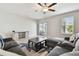 Comfortable living room with tile floors, a sectional sofa, and sliding glass doors to the outdoor patio at 13529 Wild Ginger St, Riverview, FL 33579