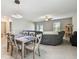 Open-concept living room features tile floors, ceiling fan, and offers a view of the patio and backyard at 13529 Wild Ginger St, Riverview, FL 33579
