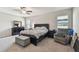 Spacious main bedroom with a ceiling fan, carpet flooring, and natural light from the windows at 13529 Wild Ginger St, Riverview, FL 33579