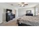 Bright main bedroom with carpet flooring, ceiling fan, and black furniture with lots of space at 13529 Wild Ginger St, Riverview, FL 33579