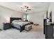Large main bedroom featuring a ceiling fan, carpet flooring, and views of the outside at 13529 Wild Ginger St, Riverview, FL 33579
