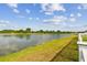 Scenic view of the expansive pond, lush greenery, and manicured lawn at 13529 Wild Ginger St, Riverview, FL 33579