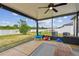 Screened porch with an outdoor seating area, perfect for enjoying the weather at 13529 Wild Ginger St, Riverview, FL 33579