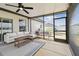 Relaxing screened porch featuring a ceiling fan, comfortable seating, and outdoor view at 13529 Wild Ginger St, Riverview, FL 33579