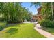Lush backyard with a pool, a gazebo, lawn area and lots of trees at 136 W Davis Blvd, Tampa, FL 33606