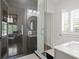 Updated bathroom featuring walk-in shower, modern vanity, and plenty of light at 136 W Davis Blvd, Tampa, FL 33606
