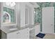 Bathroom vanity with granite counters and dual sinks, with wallpaper and lighting at 136 W Davis Blvd, Tampa, FL 33606