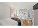 Bright bedroom with hardwood floors, large windows, a modern chandelier, and an adjacent bathroom at 136 W Davis Blvd, Tampa, FL 33606