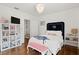 Bright bedroom featuring hardwood floors, a large bookshelf, and stylish navy and white accents at 136 W Davis Blvd, Tampa, FL 33606