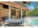 Inviting covered patio with seating beside pool, perfect for outdoor relaxation and overlooking the backyard at 136 W Davis Blvd, Tampa, FL 33606