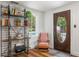 Inviting entryway with unique shelving, a cozy chair, and a view of the pool through the front door at 136 W Davis Blvd, Tampa, FL 33606
