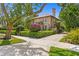 Charming two-story home with a well-manicured front yard and vibrant landscaping at 136 W Davis Blvd, Tampa, FL 33606