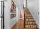 Bright hallway with colorful tiled stairs, hardwood floors, and decorative artwork at 136 W Davis Blvd, Tampa, FL 33606