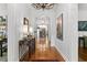 Elegant hallway featuring hardwood floors, decorative lighting, and stylish decor at 136 W Davis Blvd, Tampa, FL 33606