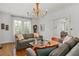 Bright living room with hardwood floors, neutral tones, and a decorative chandelier at 136 W Davis Blvd, Tampa, FL 33606