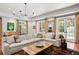 Open living room featuring a neutral sectional, large windows, and access to the pool at 136 W Davis Blvd, Tampa, FL 33606