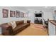 Cozy living room featuring a leather sofa, a TV, a vibrant rug, and baseball themed decorations at 136 W Davis Blvd, Tampa, FL 33606