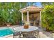 Outdoor kitchen and dining area with seating beside pool, perfect for outdoor dining in a private backyard setting at 136 W Davis Blvd, Tampa, FL 33606