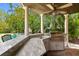 Outdoor kitchen area featuring granite countertop, sink, and grill with pillars offering a view of the pool at 136 W Davis Blvd, Tampa, FL 33606