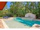 Lush backyard pool area with a water feature, lounge chairs and garden in a private and serene setting at 136 W Davis Blvd, Tampa, FL 33606