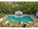 Backyard pool and spa surrounded by lush tropical landscaping provide a private oasis at 136 W Davis Blvd, Tampa, FL 33606